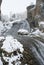 Mountains under the snow, waterfall, landscape with red rocks