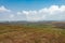 Mountainside agriculture farming fields with bright blue sky at morning from flat angle