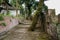 Mountainside Chinese aged buildings along ruined stone path and