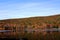 Mountainside filled with fall foliage reflecting off a lake in Allegany State Park, New York