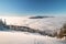 Mountainsides of the Beskydy region in the Czech Republic are sinking into a thick white inversion rising from the cities. Winter