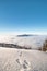 Mountainsides of the Beskydy region in the Czech Republic are sinking into a thick white inversion rising from the cities. Winter