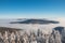 Mountainsides of the Beskydy region in the Czech Republic are sinking into a thick white inversion rising from the cities. Winter