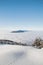 Mountainsides of the Beskydy region in the Czech Republic are sinking into a thick white inversion rising from the cities. Winter