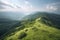 mountaintop view of endless valley filled with rolling green meadows