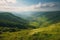 mountaintop view of endless valley filled with rolling green meadows