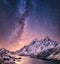 Mountans and reflection on the water surface at the night time. Sea bay and mountains at the night time. Milky way above mountains