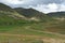 Mounted Sotho Man riding away into Lesotho Landscape