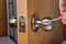 Mounting brass doorknob with exposed set-screw, close-up