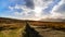 Mourn Wall on the bank of Slieve Donard mountain with blue sky, white clouds and sunrays