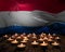 Mourning candles burning on Luxembourg national flag of background. Memorial weekend, patriot veterans day, National Day of