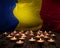 Mourning candles burning on Romania national flag of background. Memorial weekend, patriot veterans day, National Day of Service