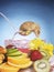 Mouse sitting on ladle watching over fruits and drink. Conceptual image