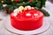 Mousse Christmas pastry cake dessert covered with red mirror glaze with new year decorations