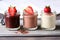 mousse trio of chocolate, vanilla, and strawberry in glass jars