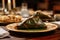 A mouthwatering assortment of food items beautifully arranged on a table for a sumptuous dining experience, Zongzi on the plate on