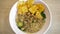 A mouthwatering bowl of Mie Ayam, a popular Indonesian dish yellow wheat noodles with diced chicken, mushrooms, and an array of