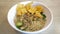 A mouthwatering bowl of Mie Ayam, a popular Indonesian dish yellow wheat noodles with diced chicken, mushrooms, and an array of