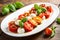 Mouthwatering Caprese salad with ripe tomatoes, fresh mozzarella, and fragrant basil leaves