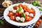 Mouthwatering Caprese salad with ripe tomatoes, fresh mozzarella, and fragrant basil leaves