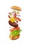 Mouthwatering cheeseburger with flying ingredients. Fast food industry