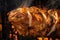 mouthwatering close-up of chicken shawarma meat roasting on a vertical spit, with charred edges and a golden-brown crust