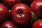 mouthwatering image of red ripe apples, adorned with water droplets, against a tempting fruity background. Ai generated