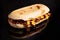 Mouthwatering sandwich with succulent meat and melted cheese on a black surface