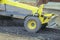 Movable motor grader with a blade performs the layout of a road crushed stone gravel base