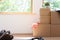 Move. Cardboard boxes for moving into a new, clean home. In a sunny day by a window in attic