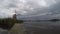 Movement of an arcus cloud of a thunderstorm over a windmill and lake in Holland