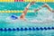 Movement of athletic swimmers swimming freestyle stroke front crawl or forward crawl during competition