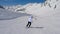 In Movement Back View, Woman Skier Skiing Downhill Of The Mountain Resort