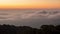 The movement of morning mist on the eastern side saw the orange horizon hitting the sunlight at Doi Inthan, Chiang Mai Province,