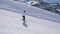 In Movement Side View, Woman Skier Skiing Down The Slope Of The Mountain On Skis