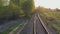 Movement on a single-track railway in the rays of the setting sun