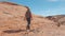 In The Movement Sporting Woman Hiking On The Red Rock Canyon In Desert