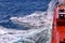 Movement of the vessel in stormy weather, Pacific Ocean. Waves and spray covering the ship during a storm