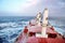 Movement of the vessel in stormy weather, Pacific Ocean. Waves and spray covering the ship during a storm