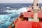 Movement of the vessel in stormy weather, Pacific Ocean. Waves and spray covering the ship during a storm