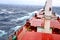 Movement of the vessel in stormy weather, Pacific Ocean. Waves and spray covering the ship during a storm