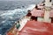 Movement of the vessel in stormy weather, Pacific Ocean. Waves and spray covering the ship during a storm