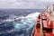 Movement of the vessel in stormy weather, Pacific Ocean. Waves and spray covering the ship during a storm