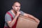 Mover man holding box making silence gesture