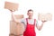 Mover man holding boxes with both hands looking sweaty