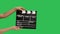 Movie clapper board clapped. Close up female hand hold empty black and white stripe film making movie slate isolated on