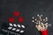 Movie clapper board, popcorn and hearts on black background. Valentine`s Day movie concept
