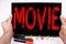 Movie text written on tablet, computer in the office with marker, pen, stationery. Business concept for Entertainment Movie Film w