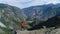 Moving above silhouette of a man standing on top of the mountain. aerial slow motion 4k