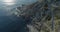 Moving backward aerial view of mediterranean sea wild green rocky coast.Nature environment outdoors travel establisher